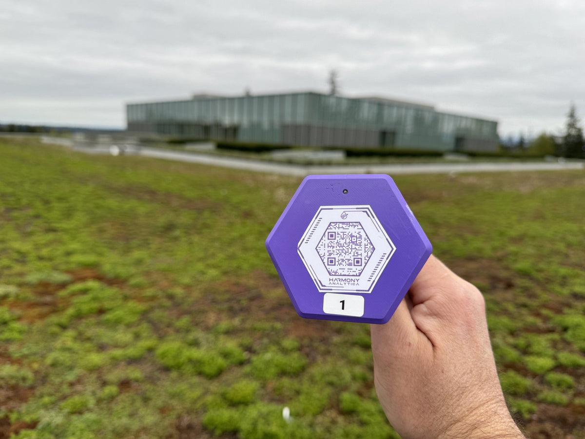 Harmony Analytica node number 1 with its QR label, on a green roof