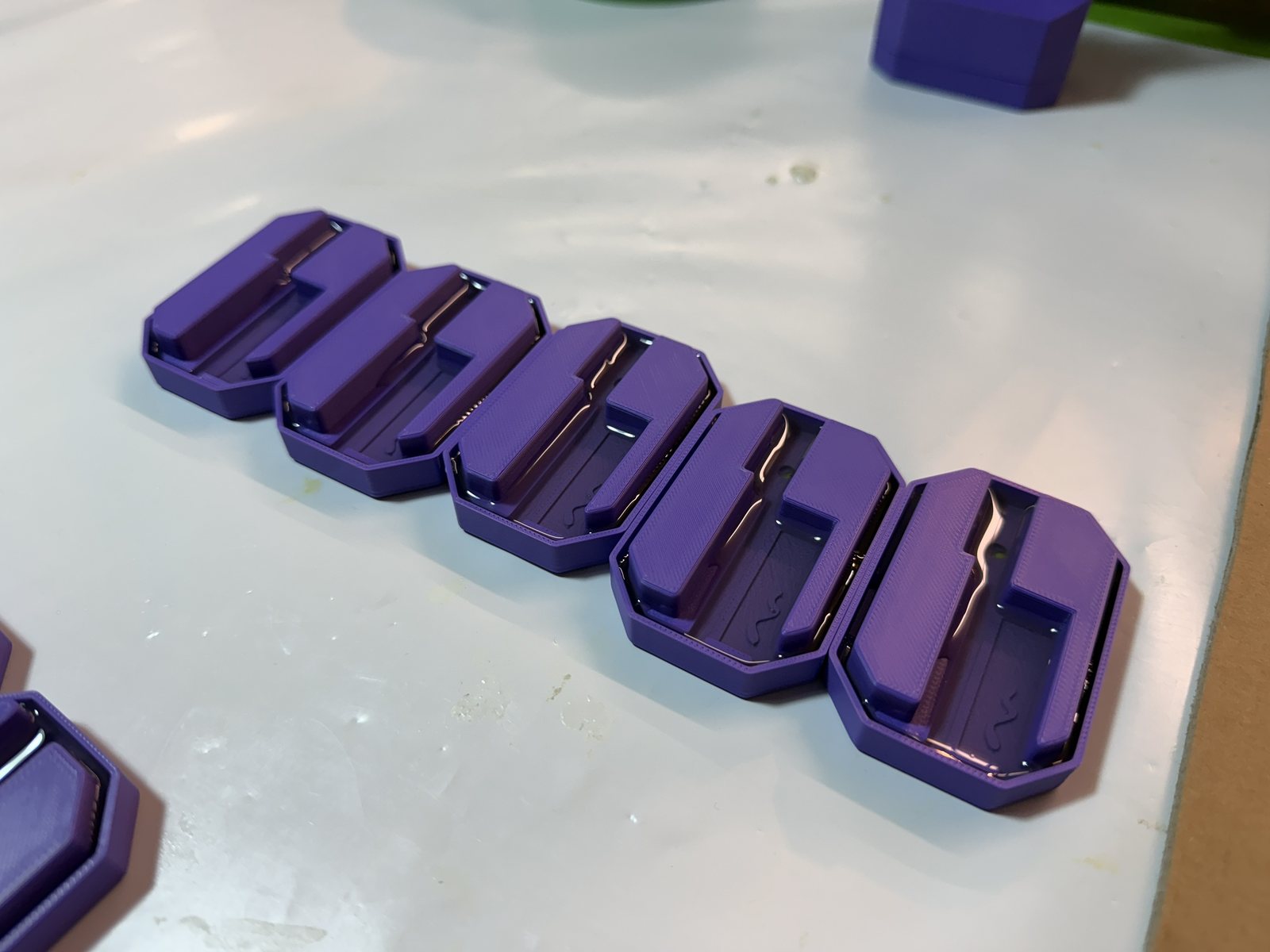 Purple 3D-printed BLADE housing bodies fresh off the printer